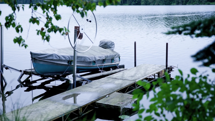 A view of the calm lake at a small dock on an overcast day in Grand Rapids, Minnesota