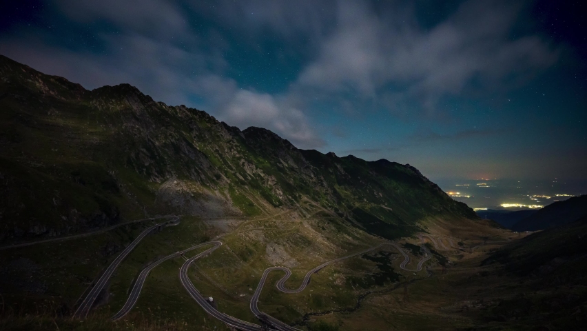 Amazing time lapse of star trails in the night sky over famous Transfagarasan mountain road in Romania.