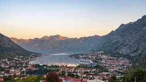 Amazing time lapse video with morning view of picturesque Kotor bay with old town and cruise ship at the port. 
