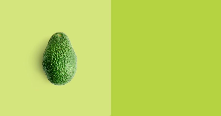 Creative animation made of avocado full an peeled on the green background. Animation concept food.  Royalty-Free Stock Footage #1097114183