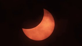 Moon Cast Shadows Covering During Partial Solar Eclipse With Clouds Moving. Partial Solar Eclipse When Sun Rise in Europe October 25, 2022. Movement of Clouds in Front of Sun During a Solar Eclipse.  - Powered by Shutterstock - Get 15% off with code: PIKWIZARD15