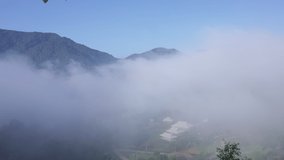 4k time lapse sea of fog move flowing over mountain and sapan village in the valley, tourist attractions and important landmarks of Nan Province Northern Thailand,  aerial view,
