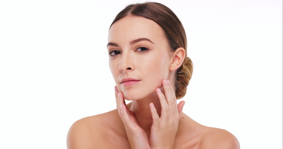 Beauty, woman touch face for facial and moisturizer, skincare with facial treatment against white studio background. Portrait, natural cosmetics and clean, health skin mockup and skin care glow.