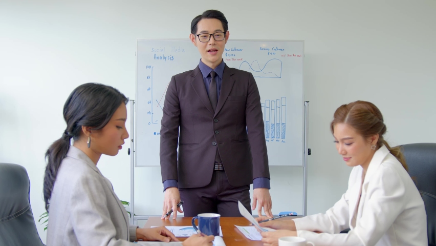 Successful business team is clapping their hands. Asian businesspeople discussion during meeting about successful of company. Royalty-Free Stock Footage #1097123399