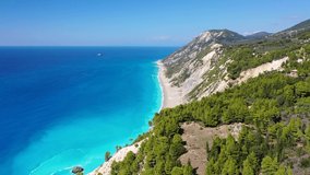 Aerial drone video of famous paradise beach of Egremni white steep rocky hills overlooking deep turquoise Ionian sea, Lefkada island