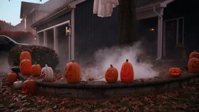 Smoke comes out of halloween pumpkins near the house. Wide shot - Powered by Shutterstock - Get 15% off with code: PIKWIZARD15