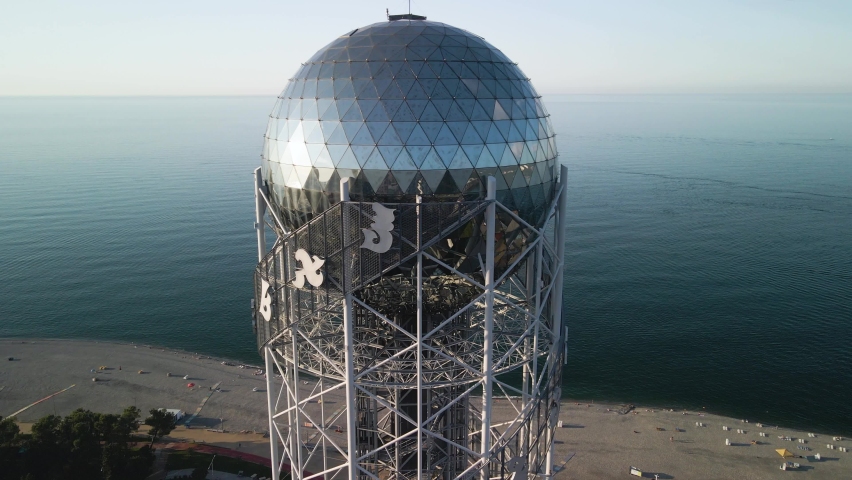 Aerial shot of the Alphabet tower in batumi georgia with the black sea behind it