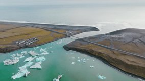 Jökulsárlón, Iceland - Glacier lake to Diamond Beach, floating ice bergs 2 - Drone video 4K colorgraded