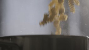 Slow motion fusilli pasta fall into boiling water - Powered by Shutterstock - Get 15% off with code: PIKWIZARD15