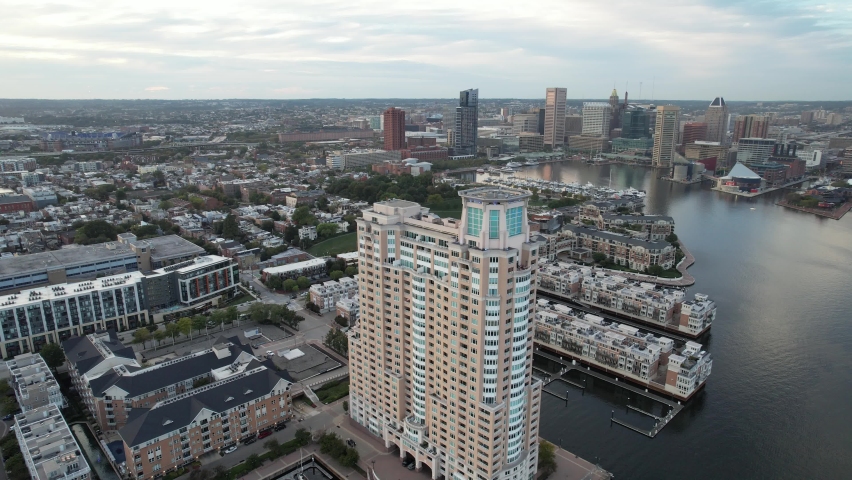 Aerial Drone Video of Apartment Building by the Baltimore City Inner Harbor at Sunset