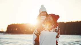 Happy young couple dating at winter sunny day outside at Christmas holidays. Family weekend spend time together. Christmas eve and love between two people. Girl and a guy have fun and laugh at sunset - Powered by Shutterstock - Get 15% off with code: PIKWIZARD15