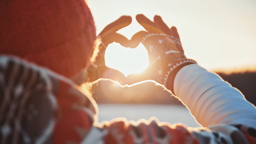 Heart valentine day Man wearing gloves make Love heart shape from hands at morning winter sunrise. Happy Christmas time. Light of sunset sun in hands at frosty cold snowy day. Christmas New Year | Shutterstock HD Video #1097141093