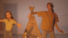 Mother and daughter dance rhythmically to the scenery of the hut. High-quality Full HD video recording. slow motion video