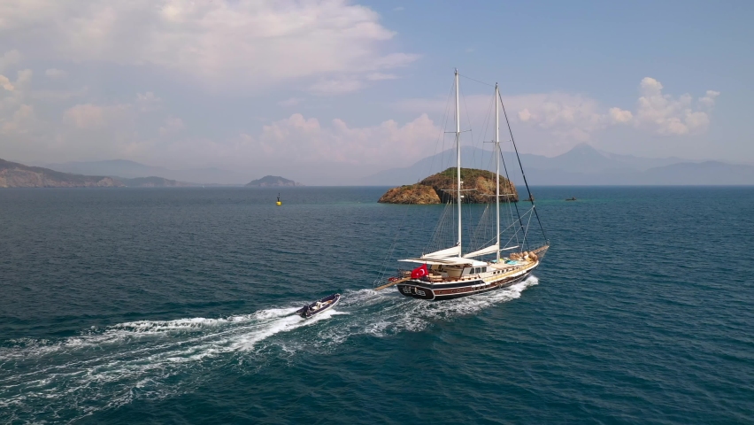 Aerial view of Sailing Gulet. A gulet is a wooden classic yacht built usually in Bodrum or Marmaris from the southwestern coast of Turkey.  Royalty-Free Stock Footage #1097150585