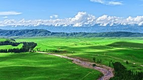Aerial footage of green grassland natural scenery in Xinjiang, China. Nalati Scenic spot is one of the most beautiful grasslands in China.