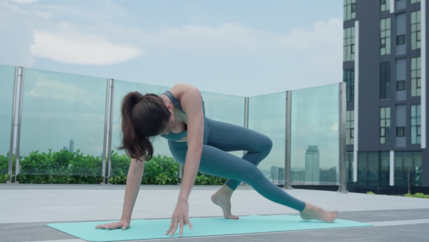 Slim woman practicing yoga on the balcony of her condo. Asian woman doing exercises in morning. balance, meditation, relaxation, calm, good health, happy, relax, healthy lifestyle concept | Shutterstock HD Video #1097154941