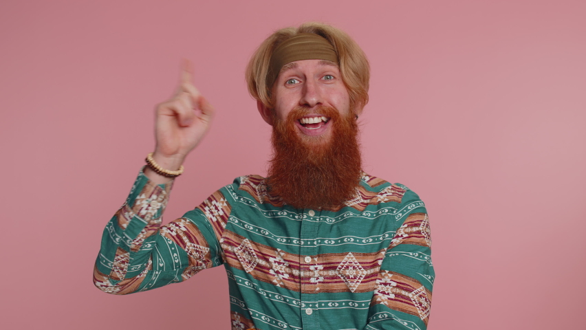 Eureka! Inspired hippie man in pattern shirt pointing finger up with open mouth, showing Eureka gesture, solution, idea, inspiration, answer. Young redhead guy isolated on pink studio wall background | Shutterstock HD Video #1097167071