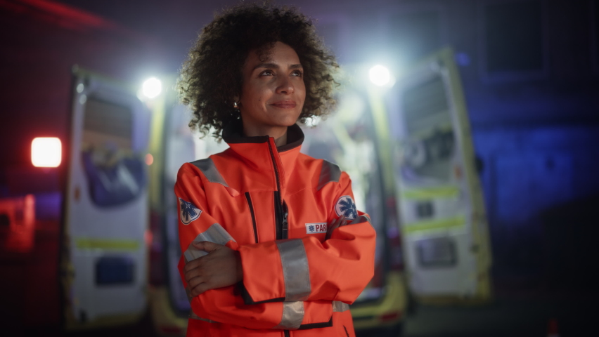 Portrait of Beautiful, Multiethnic, Female Paramedic Specialist on Late Night Shift. Heroic Empowering Woman Smiling and posing for Camera, Reporting for Duty to Save Lives and Treat Emergencies Royalty-Free Stock Footage #1097167575