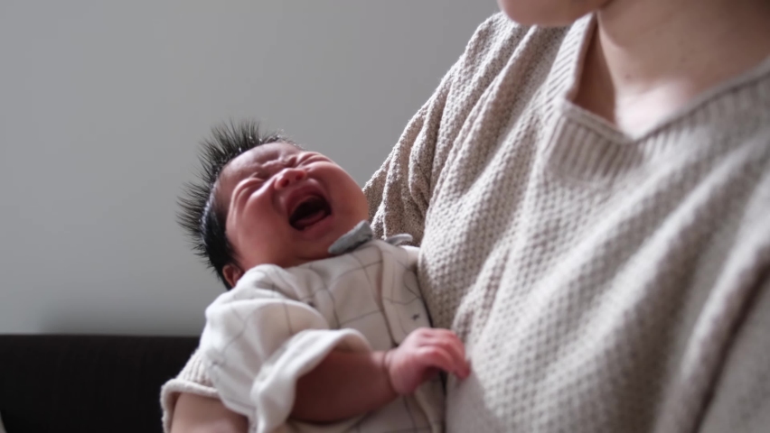 A video of a mother holding a crying 1-month-old 0-year-old newborn Royalty-Free Stock Footage #1097167817