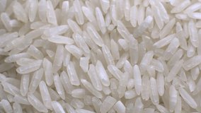 White polished long rice close-up in macro mode rotates in a circle. grocery background high dynamic range