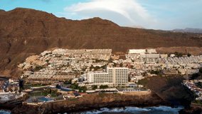 Aerial 4K drone footage of Puerto Santiago and Los Gigantes, Tenerife, Canary Islands. Coastline with cliffs and ocean video during a sunset