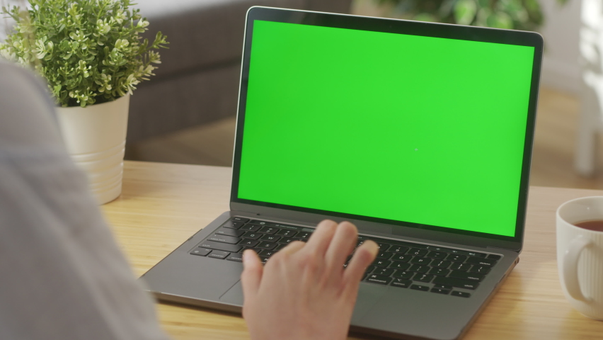 Close-up of a Woman's Hands Working on Green Screen on a Laptop Scrolling, Surfing Web. Close-up On the Hands of the Female Specialist Works on a Laptop Computer with Mock-up Green Screen Royalty-Free Stock Footage #1097172653