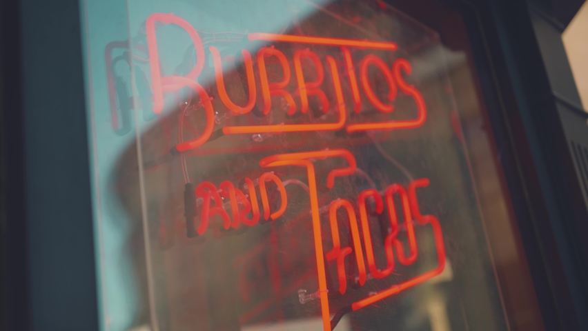 Neon Burritos and Tacos sign in Mexican restaurant window Royalty-Free Stock Footage #1097173593