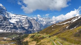 Switzerland mountains with icy glaciers on a sunny day, aerial view of mountain Swiss Alps landscape, picturesque mountain valley. High quality 4k footage