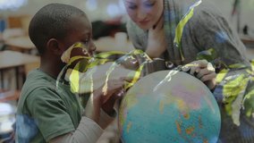 Animation of leaves over diverse schoolchildren and teacher looking at globe. Global education, learning and nature concept digitally generated video