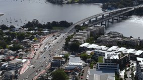 Drone shot of the Iron Cove bridge and bustle of big city. city ​​with big river flow.