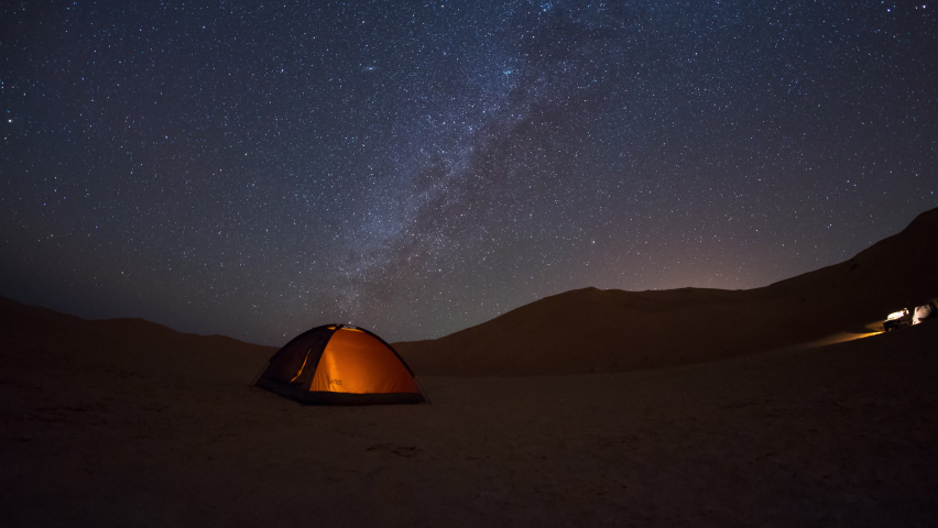 4K motion time lapse of night sky milky way camping in the desert. Royalty-Free Stock Footage #1097184571