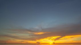 timelapse Scene of romantic sky sunset with cloud moving in the sky. 
beautiful golden sky at sunset above ocean in nature and travel concept.
sunset landscape Amazing cloudy sky of nature background.