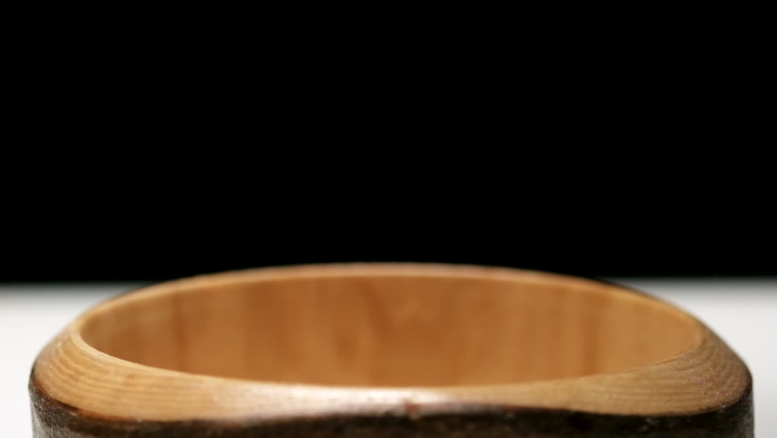 Pouring oatmeal in slow motion in a wooden bowl | Shutterstock HD Video #1097192601