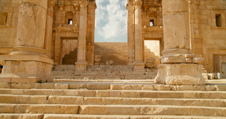 Entering through stairs of Artemis Temple Esplanade with colonnade of columns in Jerash, Jordan. Building created on Roman ruins and one of Seven Wonders. Ancient architecture. 4k steadycam shot Royalty-Free Stock Footage #1097196639