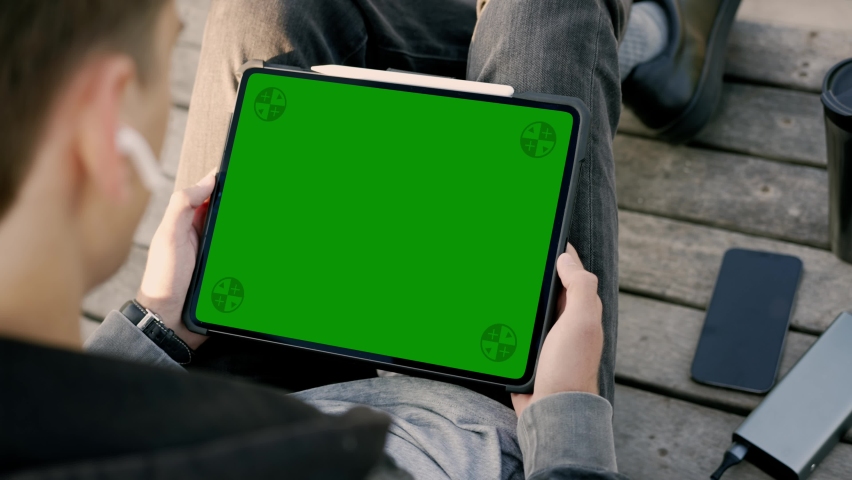 Male Working Outdoor with Tablet Computer