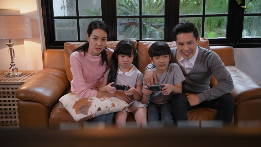 Family concept of 4k Resolution. Parents and children are having fun playing games together in the living room. | Shutterstock HD Video #1097197179