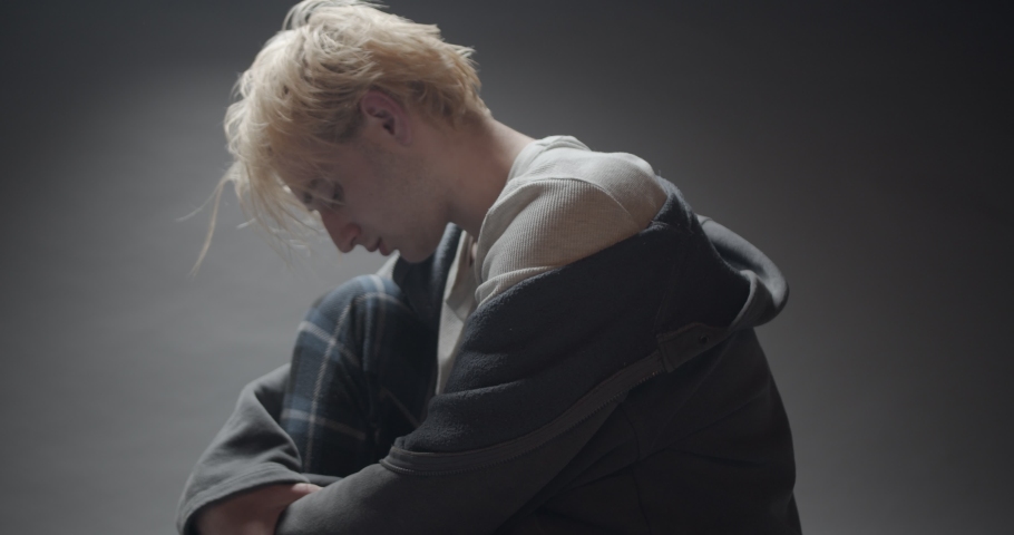 Young broken boy is thinking about the pain while looking at the letter | Shutterstock HD Video #1097198555