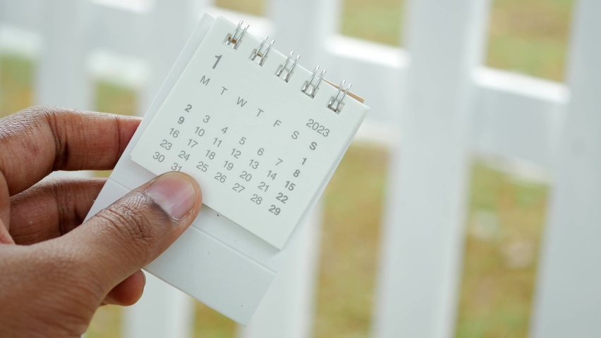 close up of holding a 2023 year calendar 