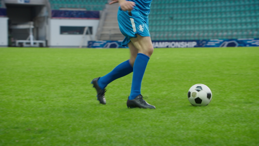 Professional Soccer Football Match Championship: Blue Team Players Attacks, Loses Ball to Foul. Action Game on a International Tournament. Slow Motion Athlete Fall on the Grass