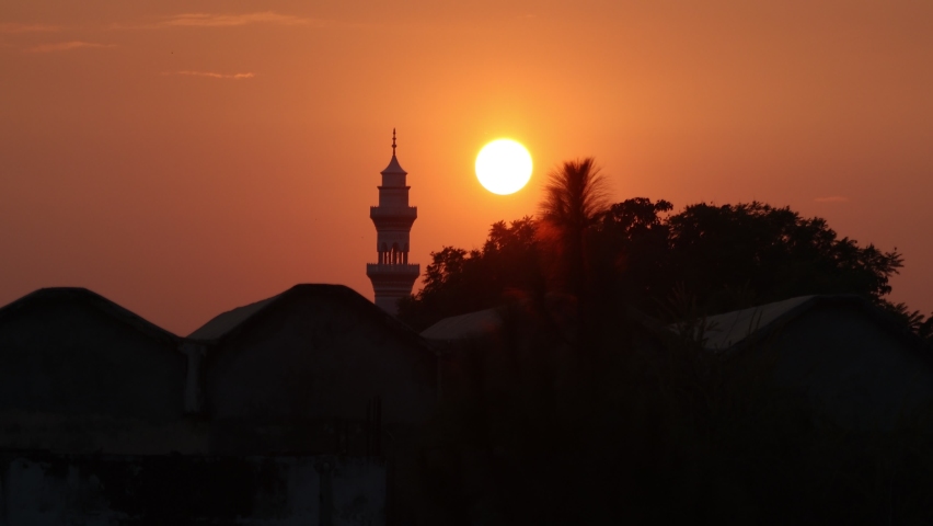 The sunset behind a minaret.