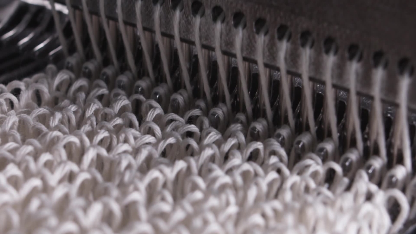 Closeup of weaving mechanism is fabricating synetic MOP