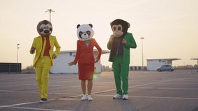 cinematic and storytelling video of a group of friends having fun and celebrating outdoor wearing funny mascots costumes	
