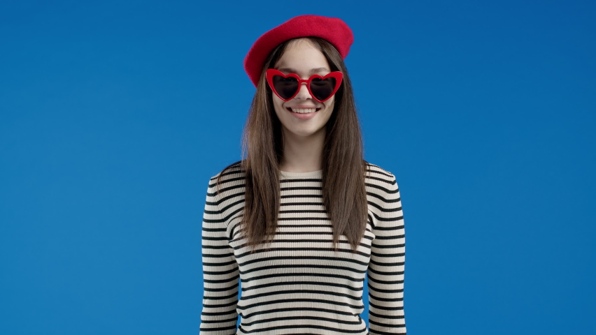 Happy woman shows triumph yes gesture, she heard great news, achieved result, goals. French girl happy, surprised excited teenager on blue background. Jackpot concept. | Shutterstock HD Video #1097208067