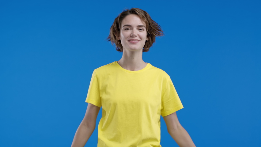 Smiling woman applauding on blue background. Happy lady emotional claps hands, congratulating. Support, cheering, gratitude concept | Shutterstock HD Video #1097208101