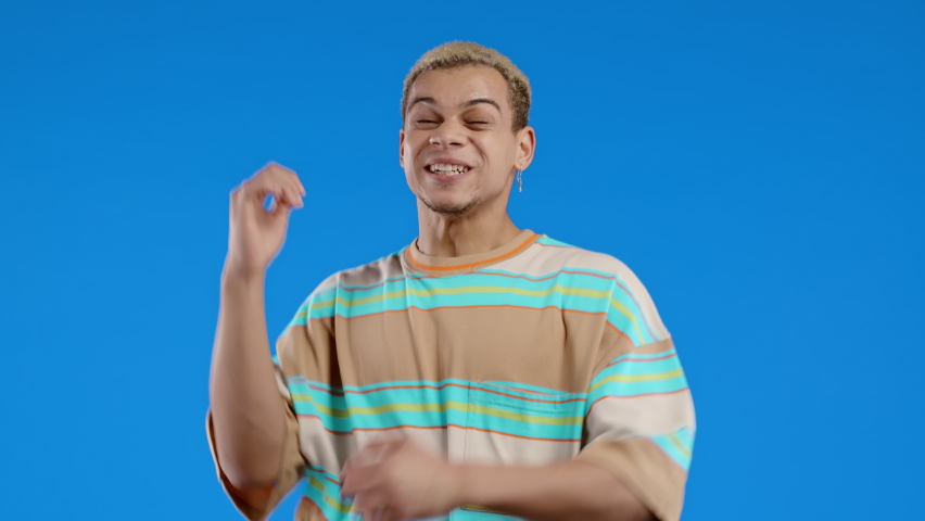 Happy man shows triumph yes gesture of victory, he achieved result, goals. Guy glad, happy, surprised excited on blue background. Jackpot concept. | Shutterstock HD Video #1097208107