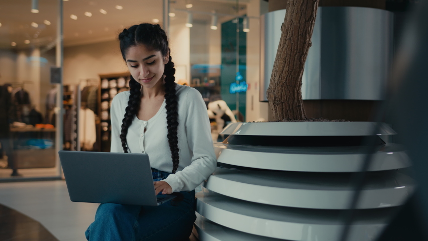 Latina businesswoman student shopper work on laptop at shopping mall make order online retail sales browsing media content e-learning arabian girl woman typing business message use internet connection | Shutterstock HD Video #1097212593
