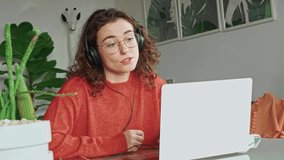 Young woman, female student or worker using laptop elearning or remote working at home office, talking looking at computer having virtual meeting, distance job interview communicating by video call.