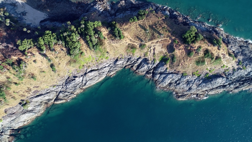 Aerial view Top down seashore wave crashing on rock cliff, Beautiful dark sea surface in sunny day summer background, Amazing seascape top view seacoast,High quality footage | Shutterstock HD Video #1097217157