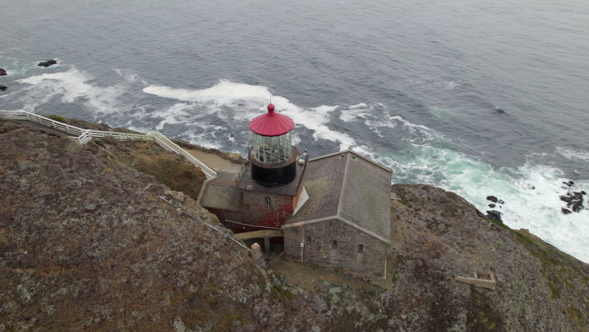 Aerial Overhead View Of Point Sur Lighthouse Beside Cliff. Orbit Motion
