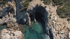 Drone view of the cliffs and the beach of Ibiza, Spain. tilt down shot.